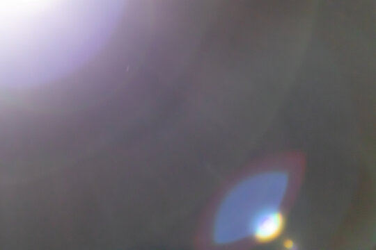 Warm lens flare overlay with light leaks and bokeh