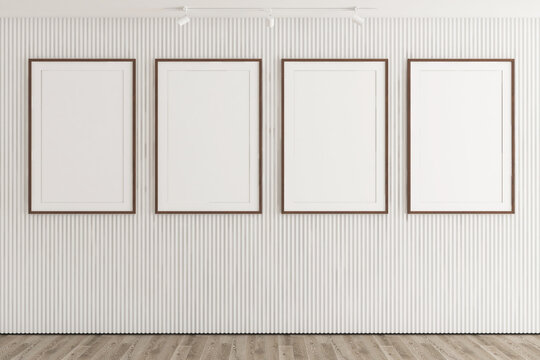 Modern mockup of four blank vertical wooden frames on green wooden slat wall paneling. 4