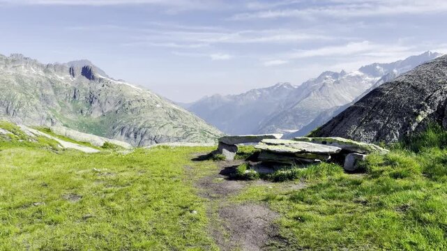 Rustic stone slab bench at an alpine viewpoint above the deep