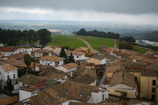 Rooftops of Baeza with countryside under storm clouds, Jaen, Spain