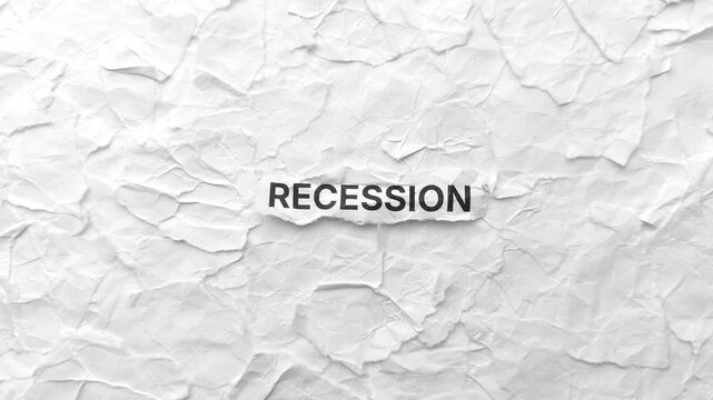Crumpled piece of paper with word Recession on torn crumpled white paper pieces background.