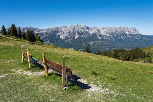 Wooden benches with Wilder Kaiser mountain view in Tyrol, Austria