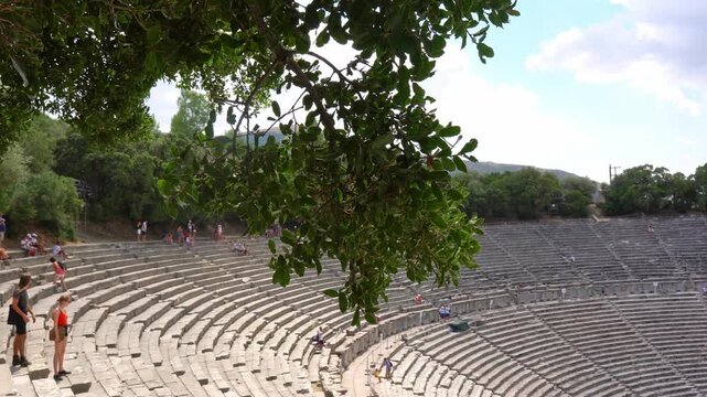 Ancient Theatre of Epidaurus revealing from behind trees