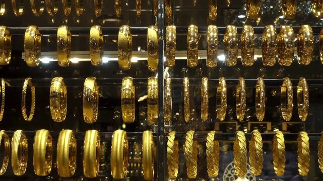Golden bangles gleam under bright display lights