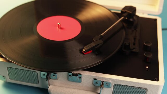 Vintage record player with spinning vinyl and red label plays music