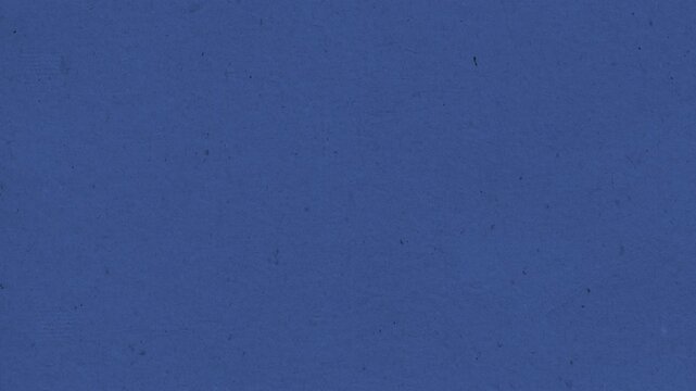 Deep blue textured paper surface video animation showing subtle grain and organic fiber movement in light