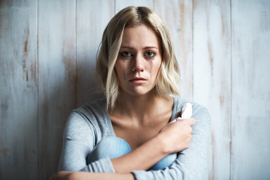 Wooden wall, portrait and woman with tears, crying and sad with anxiety and frustrated after mistake. Mental health, stress and person with depression, grief and mourning with broken heart or regret