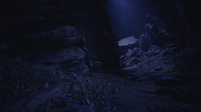 Low cavern floor under focused shaft, explorer route implied, scattered rubble and rough ledges, cold blue atmosphere evokes tension and anticipation, strong