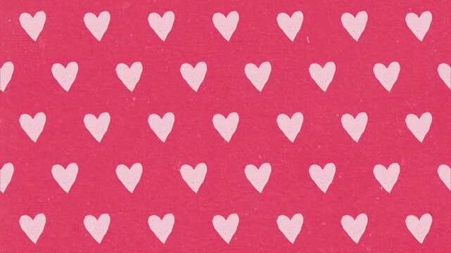 Pink hearts pattern moving across a vibrant red background in this seamless digital motion video animation