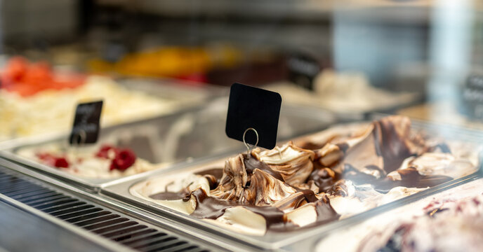 Creamy gelato with chocolate and raspberries at shop