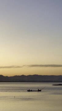 Two Fishermen in Boat at Sunrise