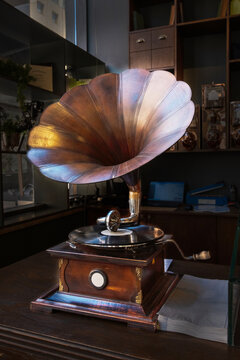 Antique classical gramophone with a wooden cabinet and a large metal horn.