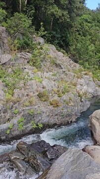 Horizontal panning shot of a scenic river basin and mini waterfall near Travo, Corsica.