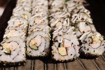 Stack of Japanese sushi maki roll in black plate. Served in Japanese bar restaurant  © cocorattanakorn