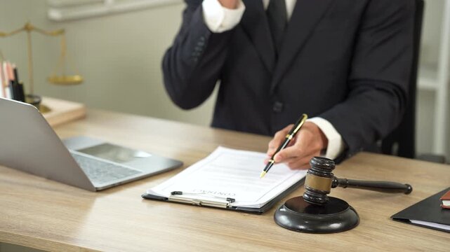 Lawyer reviewing legal documents on a laptop in a modern office, symbolizing legal consultation, justice, compliance, and professional services.