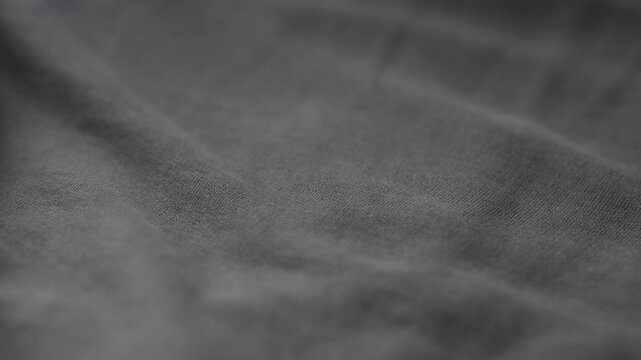 man manually check ivory color cotton fabric for clothing with hands