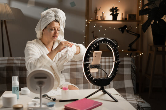 Young beauty blogger recording skincare tutorial at home