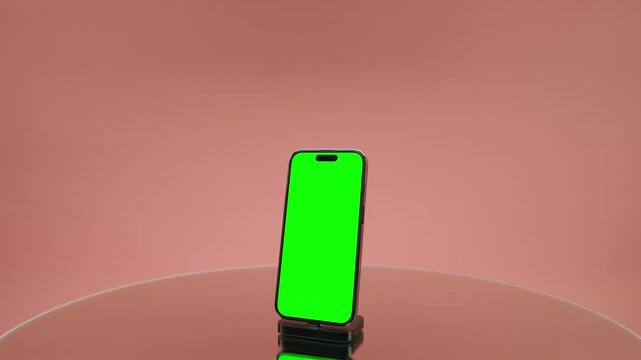 Dolly In Toward Smartphone With Green Screen on Pink
