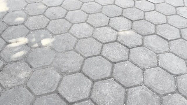 Hexagonal paving block pattern on outdoor public walkway