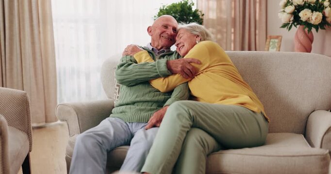 Senior couple, hug and laugh in home with love, care or discussion together in happy marriage in living room. Elderly man, old woman and funny joke or conversation for retirement, relax and embrace