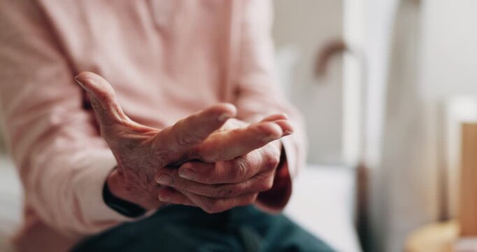 Hands, old man and discomfort in home with wrist pain, parkinson and symptoms of carpal tunnel. Senior person, massage or inflammation in bedroom with sore joints, pinched nerves and muscle stiffness