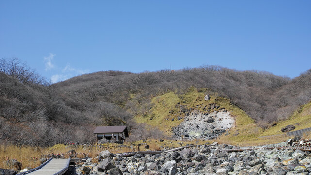 Rows of red-capped jizo statues near a volcanic steam vent at Sesshoseki, Nasu