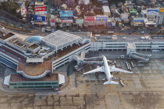 An aerial view of Fukuoka Airport apron with a Jetstar aircraft.