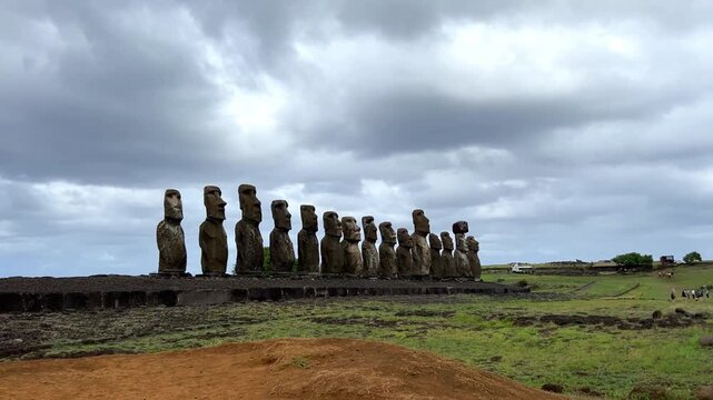 Daytime view of Ahu Tongariki on Easter Island, Chile. Fifteen iconic Moai statues standing against a bright blue sky and the Pacific Ocean. Famous archaeological site and UNESCO World Heritage 