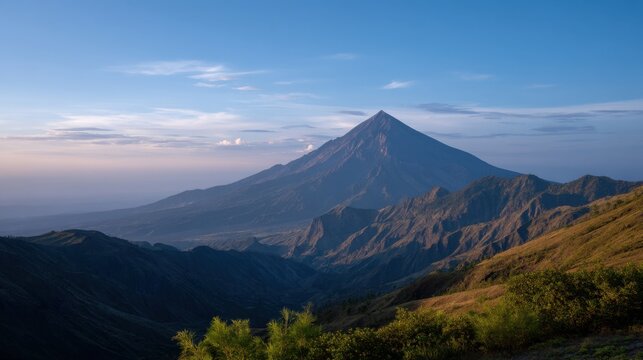 Soft Sunrise Light Bathed Volcano Peak with Glowing Horizons in Blissful Landscape