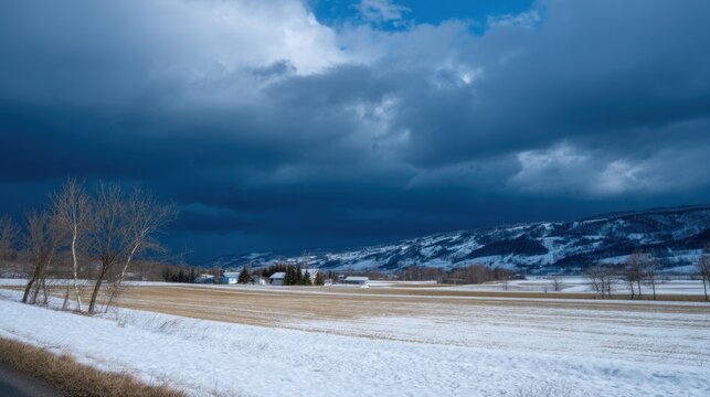 Dramatic Clouds Rolling Over Snowy Fields with Wind-Swept Trees in Winter Landscape