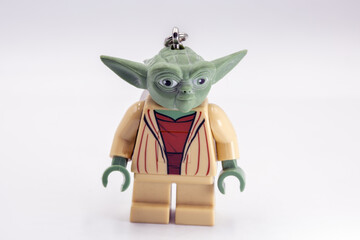 Fototapeta premium Yoda toy figure from Star Wars film closeup on white.