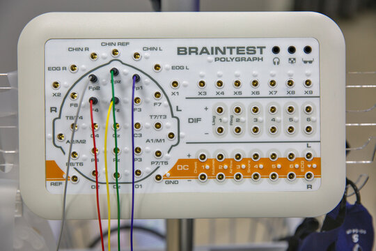 BrainTest polygraph and EEG machine with electrode caps closeup.