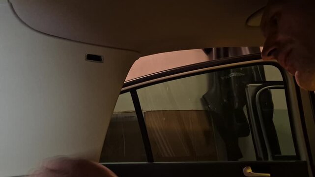 Car repair interior panel hands disassembling. Man removing trim inside vehicle