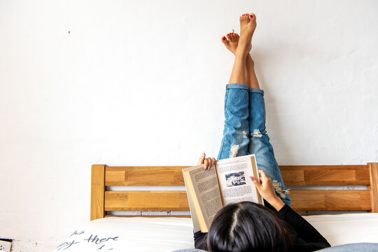 Relaxing reading in cozy bed.