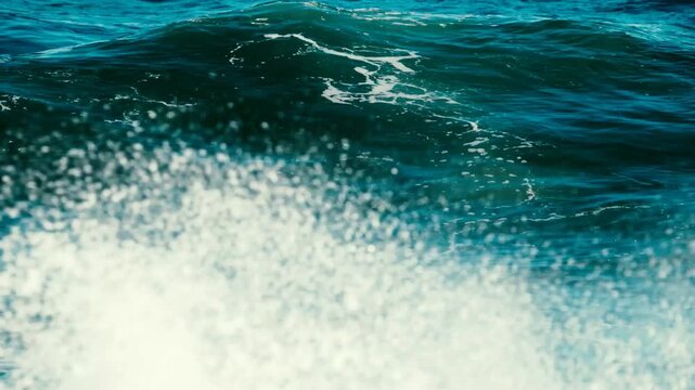 Beautiful close up view of churning green and blue sea water forming majestic cresting waves. Splashing sea foam, maritime environment, natural power background.