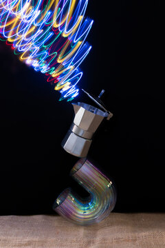 coffee maker balanced on a vase with neon light like smoke