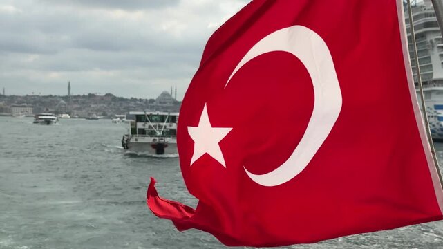 The glorious Turkish flag waves at the back of the ferry. 4k video. Istanbul, Turkey