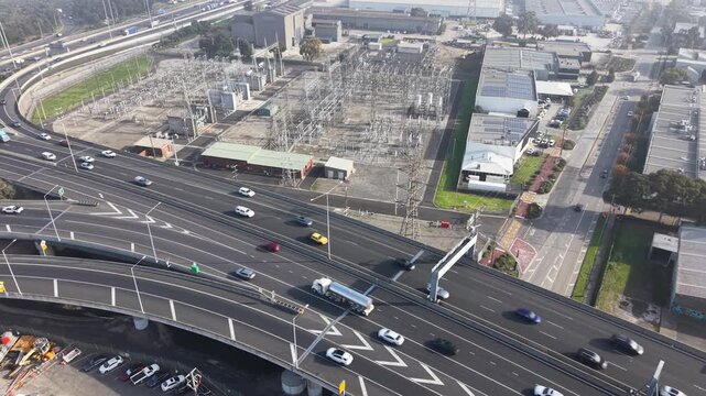 Urban freeway traffic and electrical substation aerial view