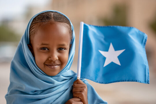 Young girl holds Somali flag in outdoor setting