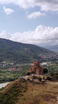 Aerial view of the historic jvari monastery, a unesco heritage site in mtskheta, georgia, overlooking the picturesque confluence of the mtkvari and aragvi rivers