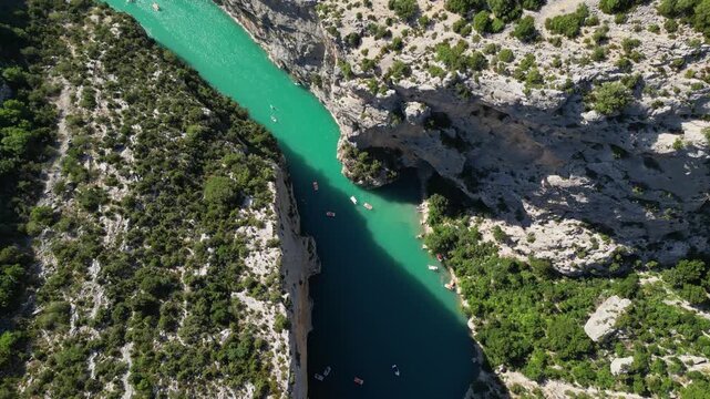 Aerial view of the turquoise waters of Verdon Gorge surrounded by dramatic limestone cliffs in Provence, France on a sunny summer day