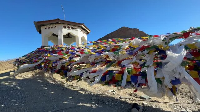 Leh Ladakh India Prayer flags floating in the wind, Leh Ladakh, North India. Buddhist prayer flags fluttering in the wind on the way to Kargil Kashmir. Tibetan Peace Flags Flying On A Hill Top.
