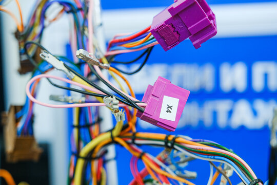 Moscow, Russia, 09.07.2026 Colorful electrical wires with plastic connector plugs. Industrial cable harness for automotive or electronic equipment. Engineering component for telecommunication and tech