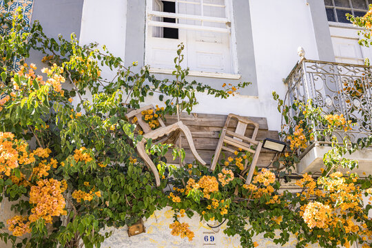 Wall decoration with chairs and orange flowers, Olh&atilde;o, Algarve, Portugal