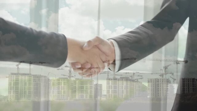 Double exposure showing a handshake combined with a busy construction site featuring multiple cranes. Symbolizes large-scale industrial partnerships and infrastructure growth.