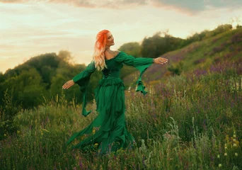 Happy fantasy woman medieval queen spinning dancing walking in summer nature field. elf girl princess have fun running at forest path green grass trees sunset sky. fairy lady, long dress looking back © kharchenkoirina