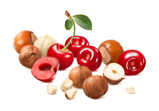 Sweet cherries, hazelnut whole nuts and pieces isolated on white background. Real photography