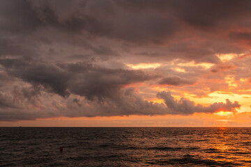 Fototapeta premium Sunset over the sea after rain with thunder clouds. Sky background.
