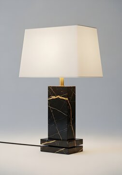 Elegant table lamp with black marble base and white lampshade on a black marble background