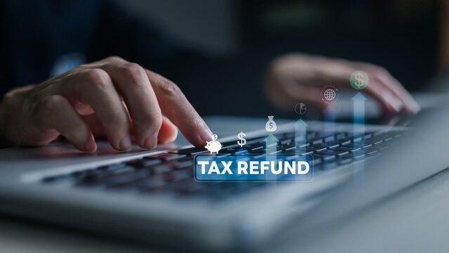 gst vat tax taxation taxes finance added accounting account accountant business payment.Close-up of hands using a laptop with a tax refund interface, showing digital GST/VAT filing and finance.